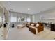 The well-lit living room features a brown sectional and a chaise lounge for comfortable seating at 17551 Black Rail St, Windermere, FL 34786