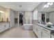 Bright and spacious main bathroom with dual vanities, a soaking tub, and walk-in closets at 17551 Black Rail St, Windermere, FL 34786