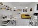 Bright office features a modern desk, comfortable yellow sofa, and ample shelving for display and storage at 17551 Black Rail St, Windermere, FL 34786