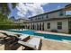 Beautiful pool area with lounge chairs, patio, and a spacious backyard view at 17551 Black Rail St, Windermere, FL 34786