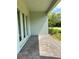 Covered back patio featuring brick pavers and double doors leading inside, great for outdoor entertaining at 2042 Key Bay Trl, Kissimmee, FL 34747