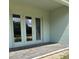 Covered back patio featuring brick pavers and double doors leading inside, great for outdoor entertaining at 2042 Key Bay Trl, Kissimmee, FL 34747