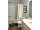 Bright bathroom featuring shower-tub combo with white tile and single sink vanity at 2042 Key Bay Trl, Kissimmee, FL 34747