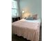 Bedroom with wood-look tile flooring, side table, and large window at 2042 Key Bay Trl, Kissimmee, FL 34747