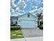 Charming single-Gathering home featuring lush landscaping, a paver driveway, and a two-car garage at 2042 Key Bay Trl, Kissimmee, FL 34747