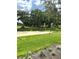 Scenic view of the golf course, showcasing the sand trap, lush green grass, and beautiful trees at 2042 Key Bay Trl, Kissimmee, FL 34747