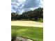 Scenic view of the golf course, showcasing the sand trap, lush trees, and beautiful cloudy sky at 2042 Key Bay Trl, Kissimmee, FL 34747
