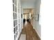 Inviting home hallway featuring wood flooring and a charming view leading to the living room at 2042 Key Bay Trl, Kissimmee, FL 34747