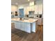 Modern kitchen featuring white cabinets, stainless steel appliances, and a spacious center island at 2042 Key Bay Trl, Kissimmee, FL 34747