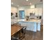 Bright kitchen with center island, breakfast bar, stainless appliances, and white cabinets at 2042 Key Bay Trl, Kissimmee, FL 34747