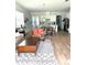 Bright living room boasts open layout, wood-look tile flooring, and stylish furniture at 2042 Key Bay Trl, Kissimmee, FL 34747