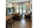 Spacious living room with backyard view, wood look tile flooring, and neutral color scheme at 2042 Key Bay Trl, Kissimmee, FL 34747