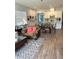 Bright living room boasts open layout, wood-look tile flooring, and stylish furniture at 2042 Key Bay Trl, Kissimmee, FL 34747