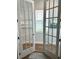 Home office with natural light streaming through the window, and glass doors leading to hallway at 2042 Key Bay Trl, Kissimmee, FL 34747