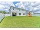 Spacious backyard features a well-maintained lawn and play structure, perfect for outdoor activities at 2149 Tudor Rose Dr, Sanford, FL 32773
