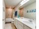 Well-lit bathroom with double vanity, neutral-toned tile, and shower-tub combination at 2149 Tudor Rose Dr, Sanford, FL 32773