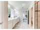 Well-lit bathroom featuring double vanities and open design flowing to the main bedroom at 2149 Tudor Rose Dr, Sanford, FL 32773