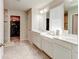 Elegant bathroom with double sinks, granite countertops, and walk-in closet at 2149 Tudor Rose Dr, Sanford, FL 32773