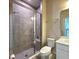 Stylish bathroom with a glass-enclosed shower featuring gray tile and a built-in seat at 2149 Tudor Rose Dr, Sanford, FL 32773