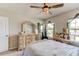 Comfortable bedroom featuring an antique vanity, plush bed, and bright windows at 2149 Tudor Rose Dr, Sanford, FL 32773