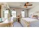 Cozy bedroom featuring an antique vanity, plush bed, and bright windows at 2149 Tudor Rose Dr, Sanford, FL 32773