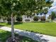 Community entrance sign surrounded by green grass, shrubs, and shade trees at 2149 Tudor Rose Dr, Sanford, FL 32773