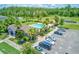 Aerial view of a community pool with lounge chairs, mature landscaping, and ample parking at 2149 Tudor Rose Dr, Sanford, FL 32773