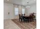 Formal dining room features a chandelier, dark wood table, and tile flooring at 2149 Tudor Rose Dr, Sanford, FL 32773