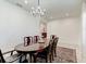 Elegant dining area with chandelier, table with seating for six, and tile floors at 2149 Tudor Rose Dr, Sanford, FL 32773