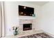 Close-up of a modern fireplace with light-colored stone surround, a mounted TV, and decorative accessories at 2149 Tudor Rose Dr, Sanford, FL 32773