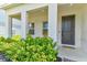 Inviting front porch with rocking chairs, decorative shrubbery, and a welcoming front door at 2149 Tudor Rose Dr, Sanford, FL 32773