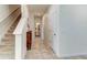 Hallway with tile flooring, staircase, closet, and entry to the downstairs bathroom at 2149 Tudor Rose Dr, Sanford, FL 32773