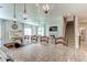 Open-concept kitchen with granite countertops, pendant lighting, and stainless steel appliances, seamlessly flowing into the living area at 2149 Tudor Rose Dr, Sanford, FL 32773