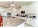 Bright kitchen featuring white cabinets, granite countertops, and a large center island at 2149 Tudor Rose Dr, Sanford, FL 32773