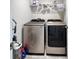 Modern laundry room featuring newer washer and dryer with functional shelving for storage at 2149 Tudor Rose Dr, Sanford, FL 32773