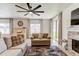 Comfortable living room featuring a piano, fireplace, ceiling fan and neutral colored furniture and decor at 2149 Tudor Rose Dr, Sanford, FL 32773