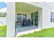 Outdoor covered patio features a grill and sliding glass door leading to a bright living room at 2149 Tudor Rose Dr, Sanford, FL 32773
