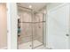 Glass enclosed tiled shower with built in bench and modern fixtures at 2149 Tudor Rose Dr, Sanford, FL 32773