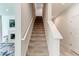 Carpeted staircase with white handrails leading to the upper level of the home at 2149 Tudor Rose Dr, Sanford, FL 32773