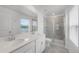 Bathroom features a double sink vanity, glass-enclosed shower, and a window with a view at 2563 Relaxing Ln, Kissimmee, FL 34744