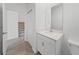 Bathroom featuring a vanity with storage, modern fixtures, and a large mirror at 2563 Relaxing Ln, Kissimmee, FL 34744