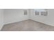 An airy bedroom featuring tile flooring, neutral walls, and two bright windows at 2563 Relaxing Ln, Kissimmee, FL 34744