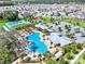Community pool and clubhouse area featuring lush landscaping, tennis courts and ample parking at 2563 Relaxing Ln, Kissimmee, FL 34744