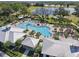 Community clubhouse area showcasing the pool with sunbathers and lush landscaping around the area at 2563 Relaxing Ln, Kissimmee, FL 34744