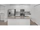 Bright kitchen with white cabinetry, stainless steel appliances, and center island for food preparation at 2563 Relaxing Ln, Kissimmee, FL 34744