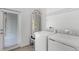 Laundry room showcasing a washer, dryer, water heater, and shelving for organized storage at 2563 Relaxing Ln, Kissimmee, FL 34744
