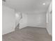 A spacious and bright living room featuring tile floors and stairs to the upper level at 2563 Relaxing Ln, Kissimmee, FL 34744