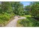 Inviting backyard area featuring a stone fire pit, lush landscaping, and serene outdoor space at 264 Agnes Ave, Longwood, FL 32750