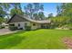 Expansive backyard showcasing the home's exterior, screened-in porch, and well-maintained lawn at 264 Agnes Ave, Longwood, FL 32750