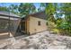 Exterior view of a backyard featuring a screened patio, brick pavers, and a well-maintained landscape at 264 Agnes Ave, Longwood, FL 32750